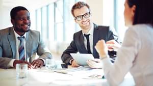 A team of business people clarify details during a meeting