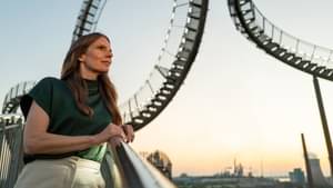Young businesswoman leaning against a railing at sunrise